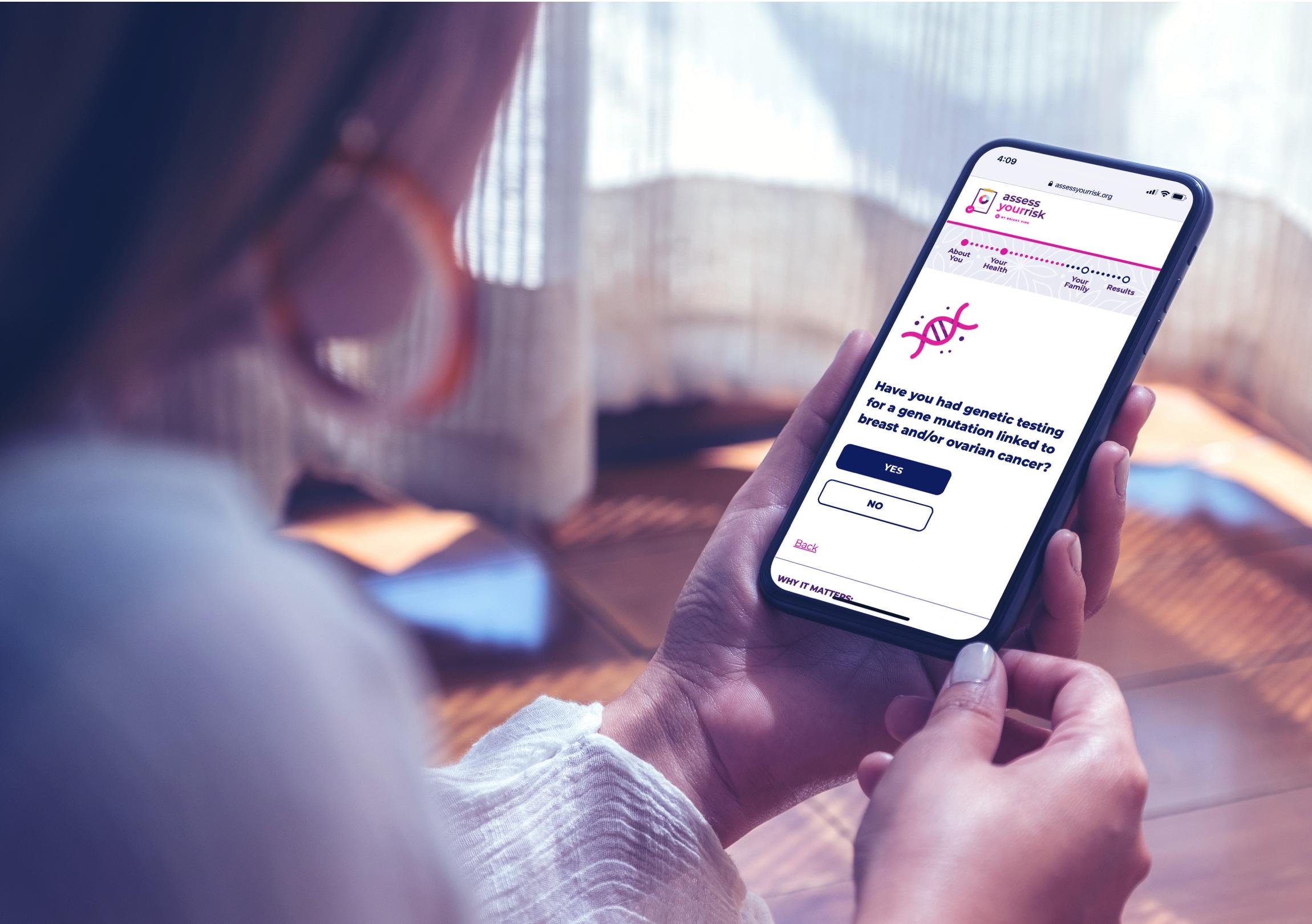Woman holding a phone with the Bright Pink site displayed