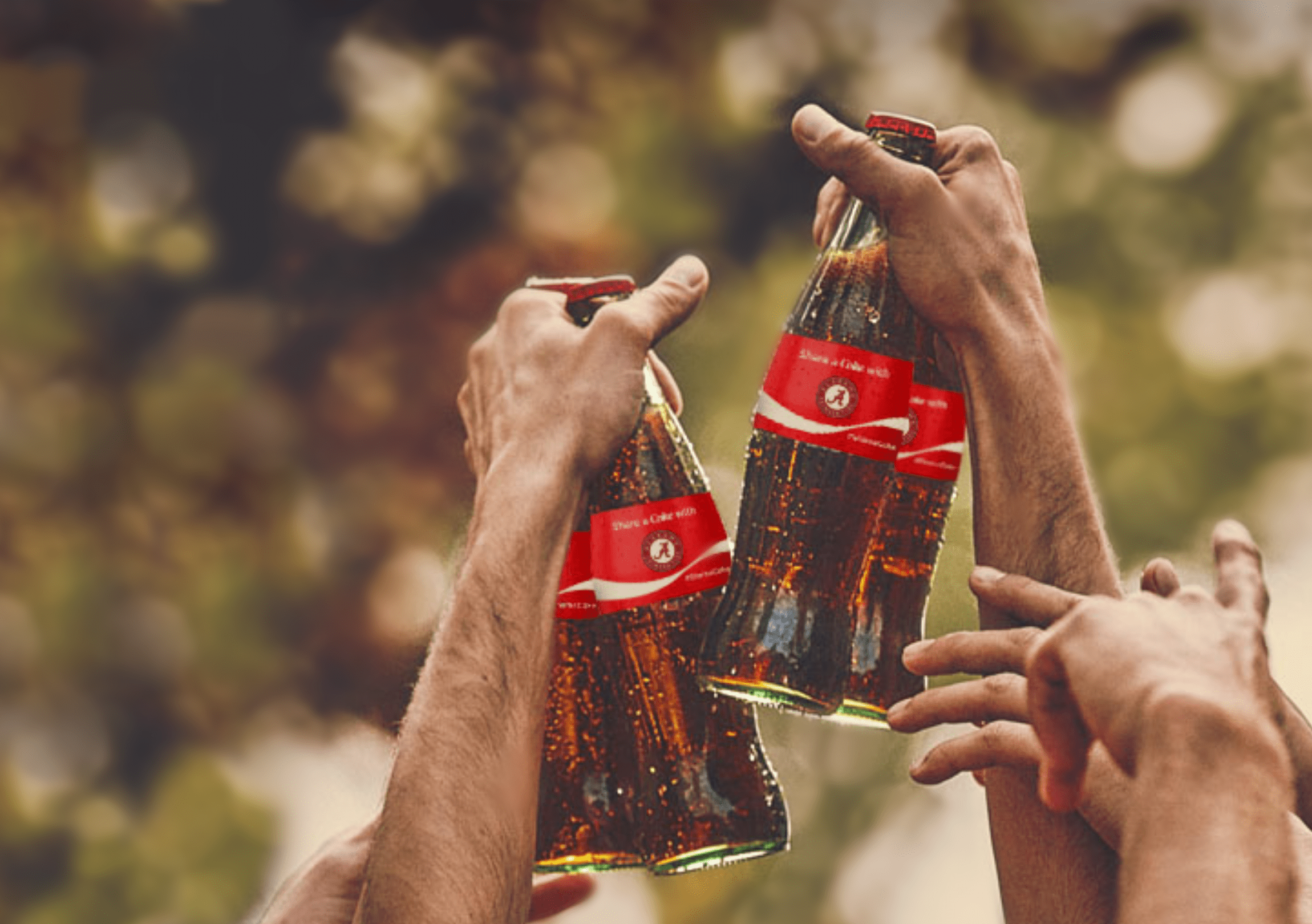 group of hands shown cheering coke bottles with Atlanta Braves logo shown