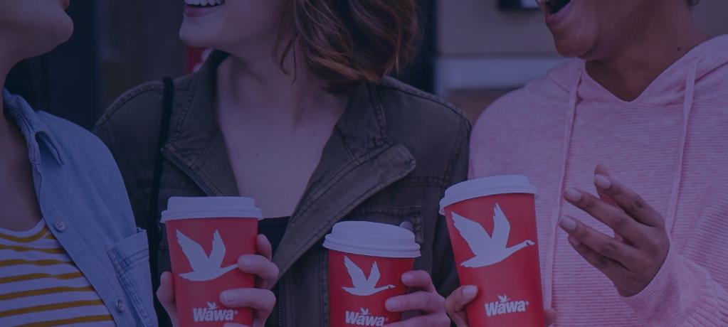 A crowd holding Wawa branded cups